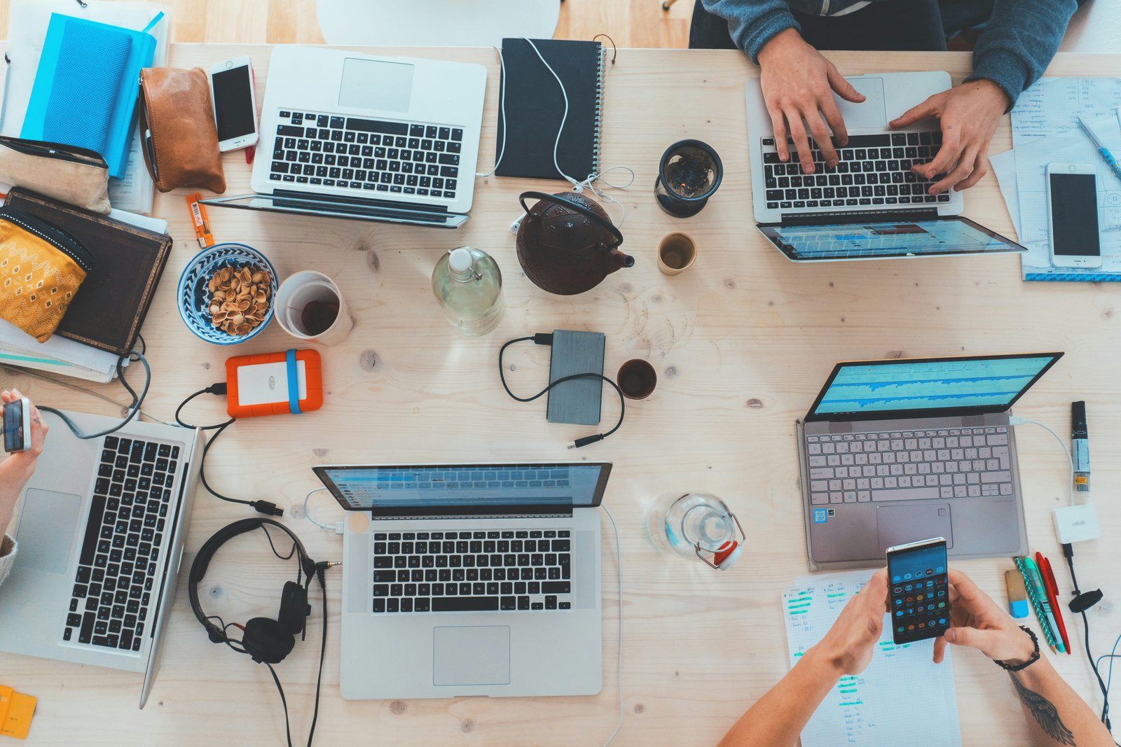 Busy home service business team working across multiple devices — the reality of managing inbound leads at scale